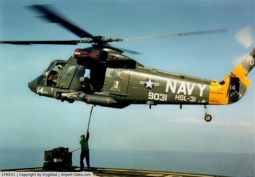 149031, Kaman HH-2D Seasprite C/N 035, Shaka 14 hooks up a cargo load from the deck of USNS Harkness (T-AGS 32)  in the Banda Sea, Indonesia, late 1986. Photo by AE2 Barry Sinclair.