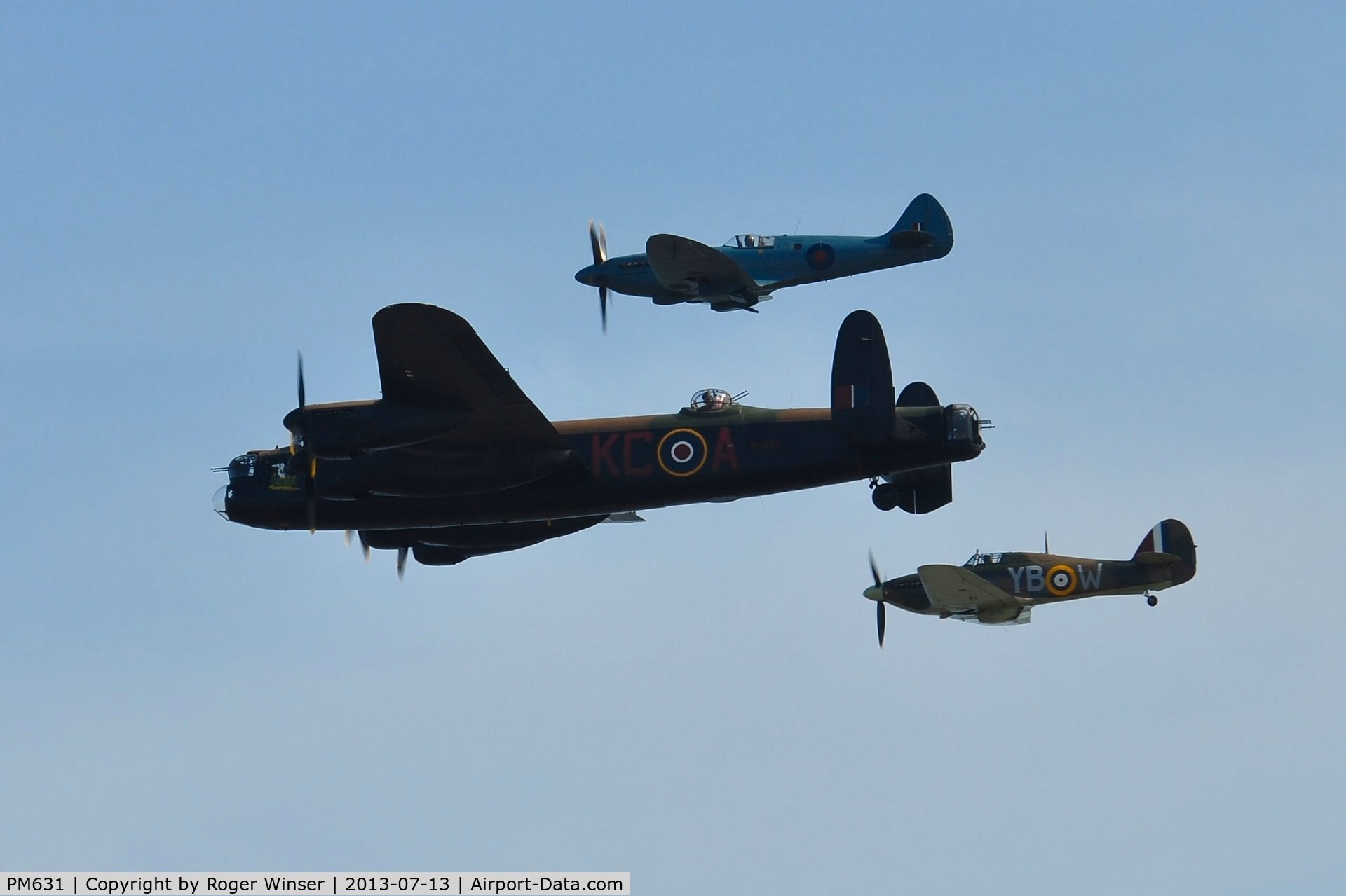PM631, 1945 Supermarine 389 Spitfire PR.XIX C/N 6S/683528, Off airport. Five Merlins and a Griffon. One of the BBMF's R-R Griffon powered Spitfire PR. XIX aircraft in formation with Avro Lancaster B.I PA474 coded KC-A and Hurricane II.c LF363 coded YB-W. Displaying on the first day of the Wales National Air Show,