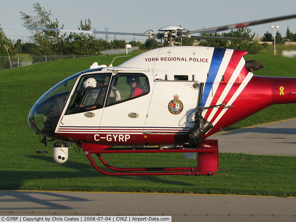 C-GYRP, 2000 Eurocopter EC-120B Colibri C/N 1086, As this Police chopper hover taxied towards the runway the guy in the front left seat kept their white nose mounted camera aimed at me. So I smiled!