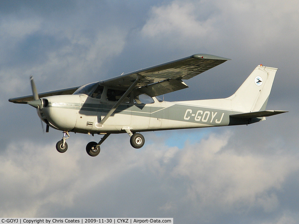 C-GOYJ, 1974 Cessna 172M C/N 17263968, As torn & frayed clouds swirled above this nice Skyhawk was about to land on 33. I've always liked the colour of this busy plane that's owned by the Toronto Airways flying club.