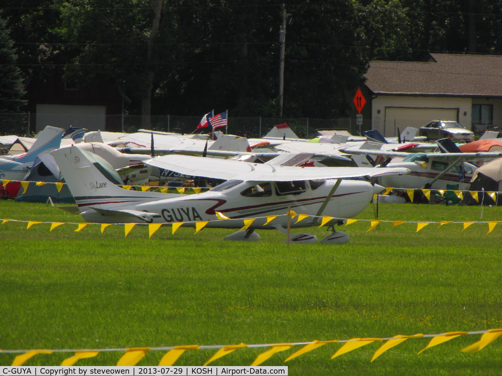 C-GUYA, 2002 Cessna 182T Skylane C/N 18281081, Taxing in the grass at KOSH