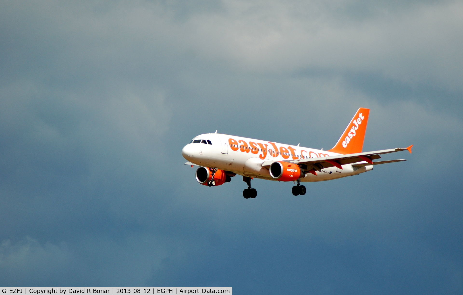 G-EZFJ, 2009 Airbus A319-111 C/N 4040, Short finals in-front of an agry sky