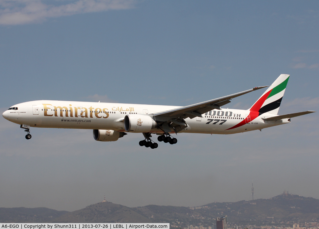 A6-EGO, 2012 Boeing 777-31H/ER C/N 35598, Landing rwy 25R with additional '1000th 777' titles for the 1000th B777 built