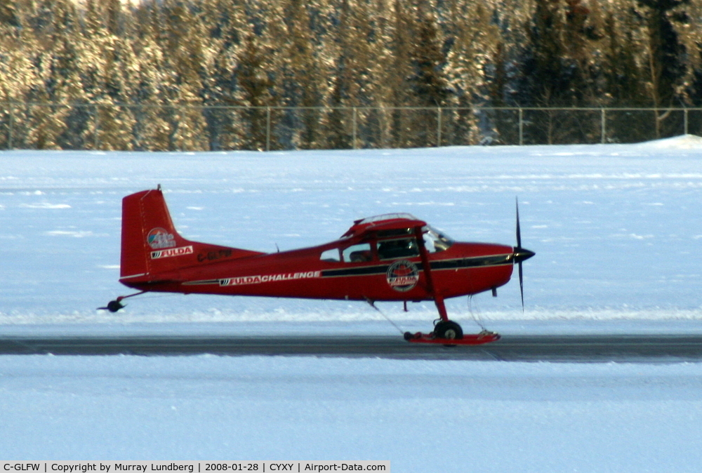 C-GLFW, 1975 Cessna 180J C/N 18052625, Taking off at Whitehorse, Yukon, equipped with wheel-skis.