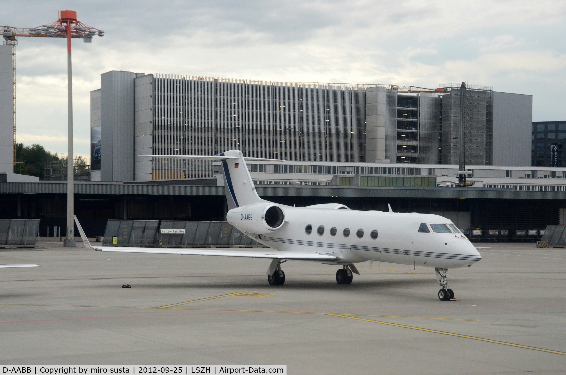 D-AABB, 2007 Gulfstream Aerospace GIV-X (G450) C/N 4091, DC Aviation Gulfstream Aerospace airplane parking at Zurich-Kloten International Airport, photo through airplane window.