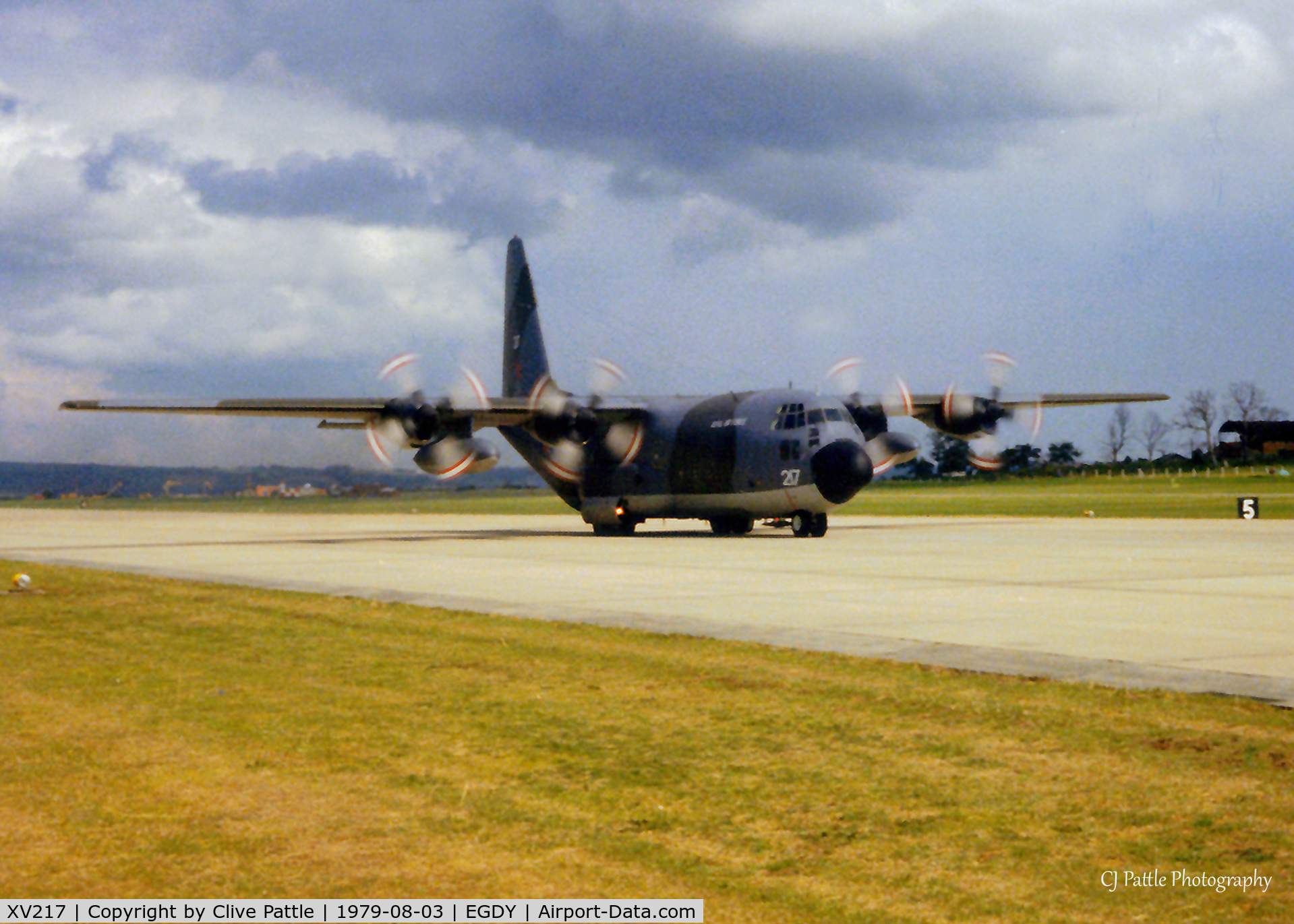 XV217, 1967 Lockheed C-130K Hercules C.1 C/N 382-4244, Scanned from print, Herc XV217 lands at RNAS Yeovilton  as the Red Arrows support aircraft for Air Day '79.