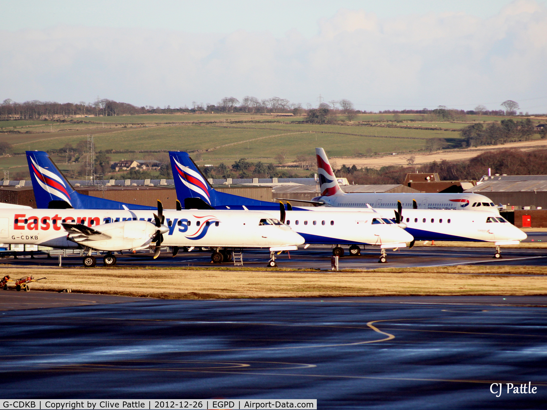 G-CDKB, 1996 Saab 2000 C/N 2000-032, 'KB, on left of line-up at Aberdeen EGPD Boxing Day sunset