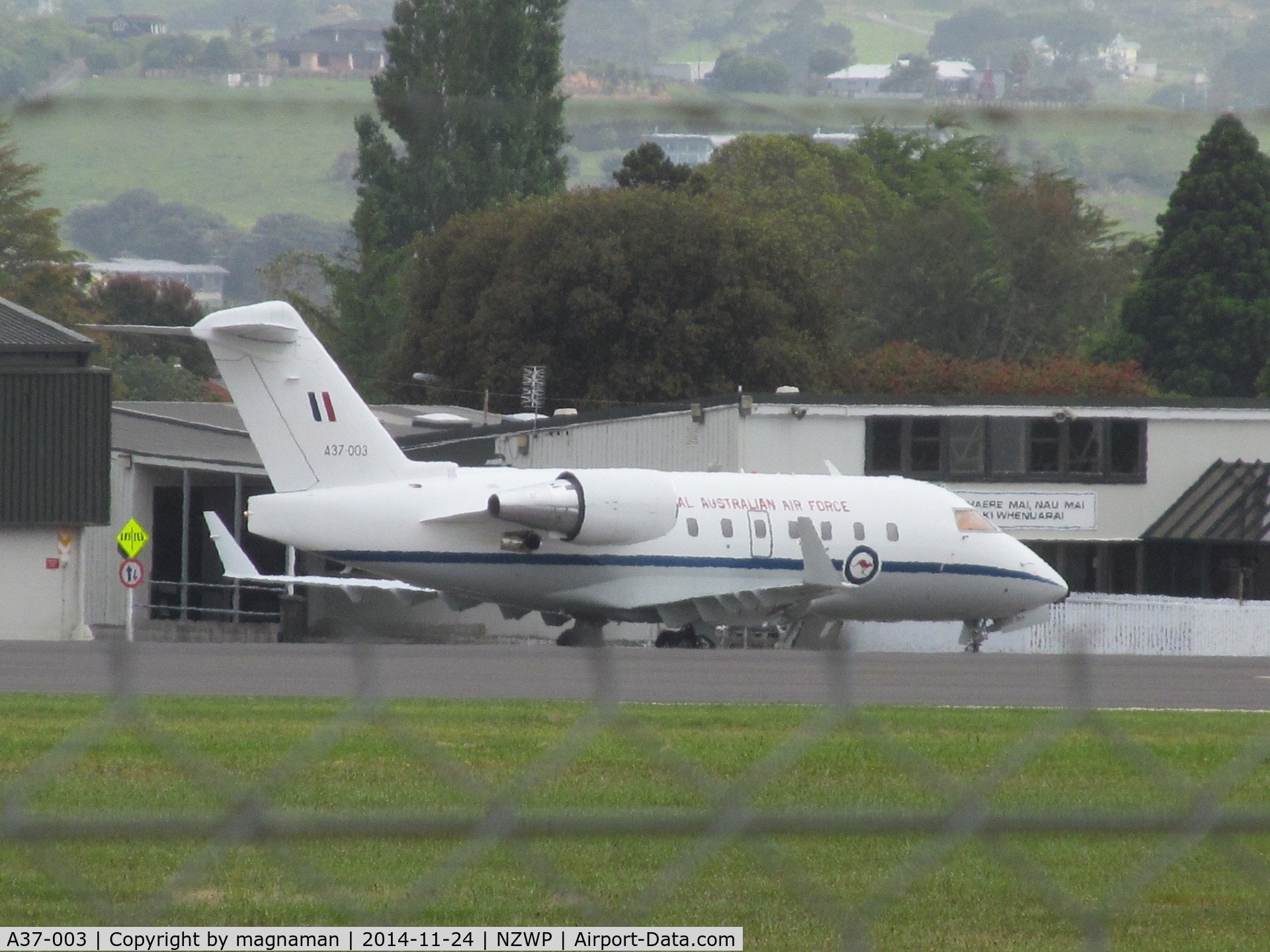 A37-003, 2002 Bombardier Challenger 604 (CL-600-2B16) C/N 5538, Shot over perimeter outer and inner fence to apron. Shame no clearer or closer vantage points at this airfield.