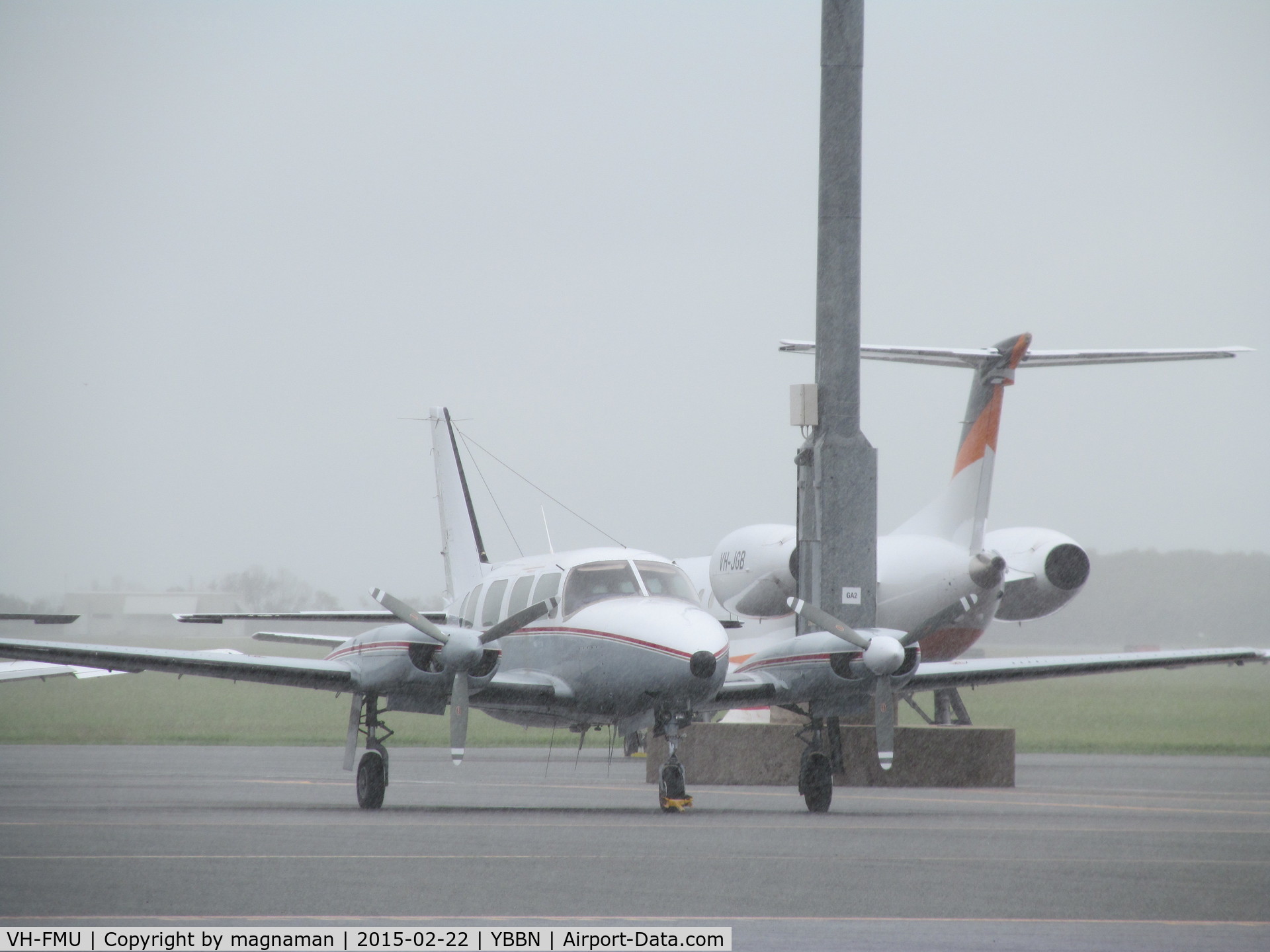 VH-FMU, 1982 Piper PA-31-310 Navajo Navajo C/N 31-8212015, with VH-JGB biz jet in background. On GA ramp.