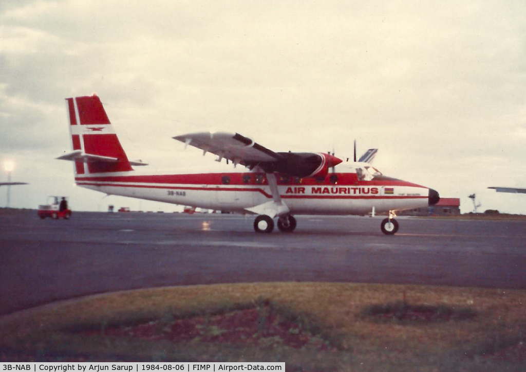 3B-NAB, 1975 De Havilland Canada DHC-6-300 Twin Otter C/N 442, 'Port Mathurin' taxiing past the terminal on a winter evening in August 1984. Scanned from a print.