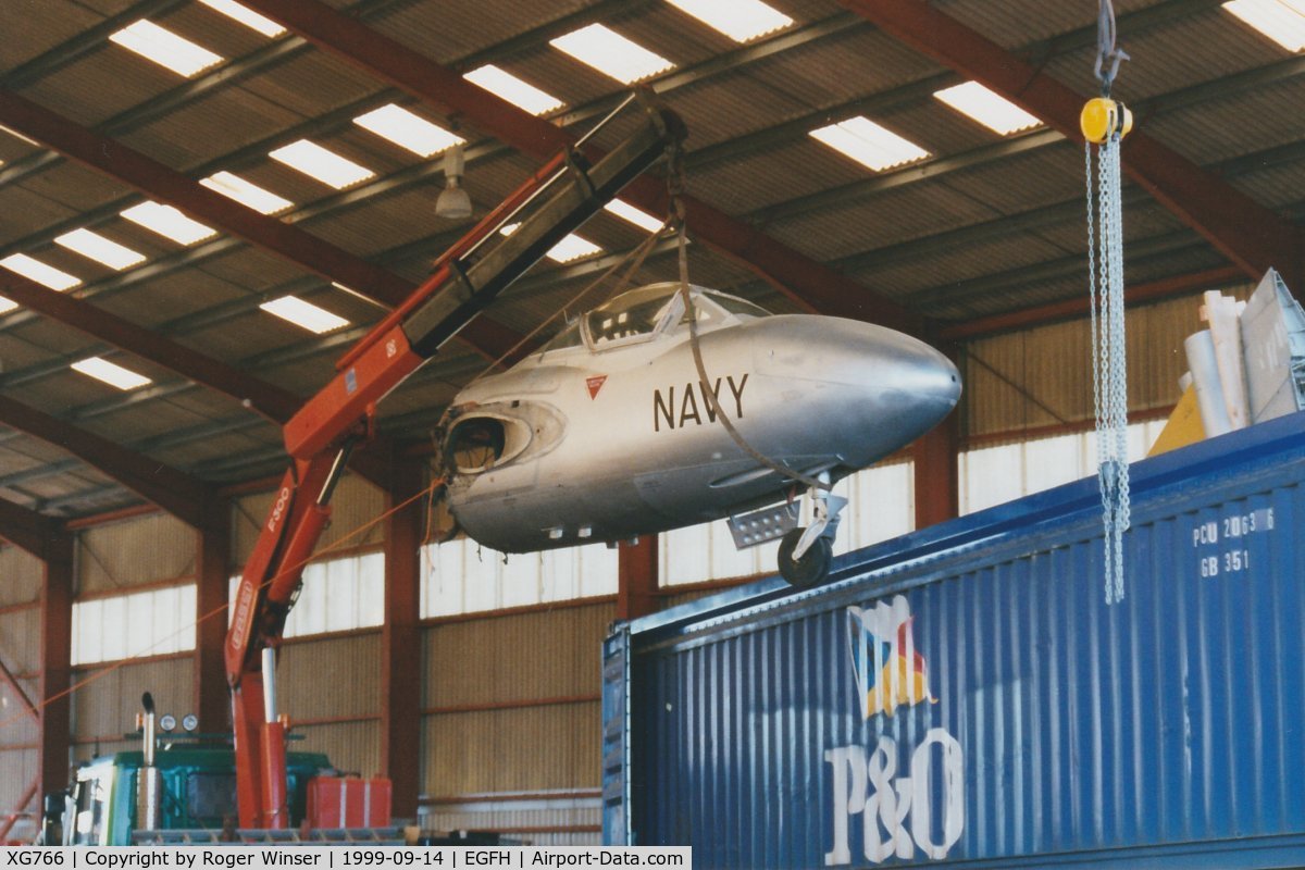XG766, 1954 De Havilland DH-115 Sea Vampire T.22 C/N 15641, The forward fuselage of an ex-RN, ex-RAN aircraft being lifted out of the container in DHA's hangar. The aircraft was coded 874/NW in RAN service when operated by 724 Squadron at Nowra, Australia. On 19/05/2000 the airframe was registered G-SPDR.