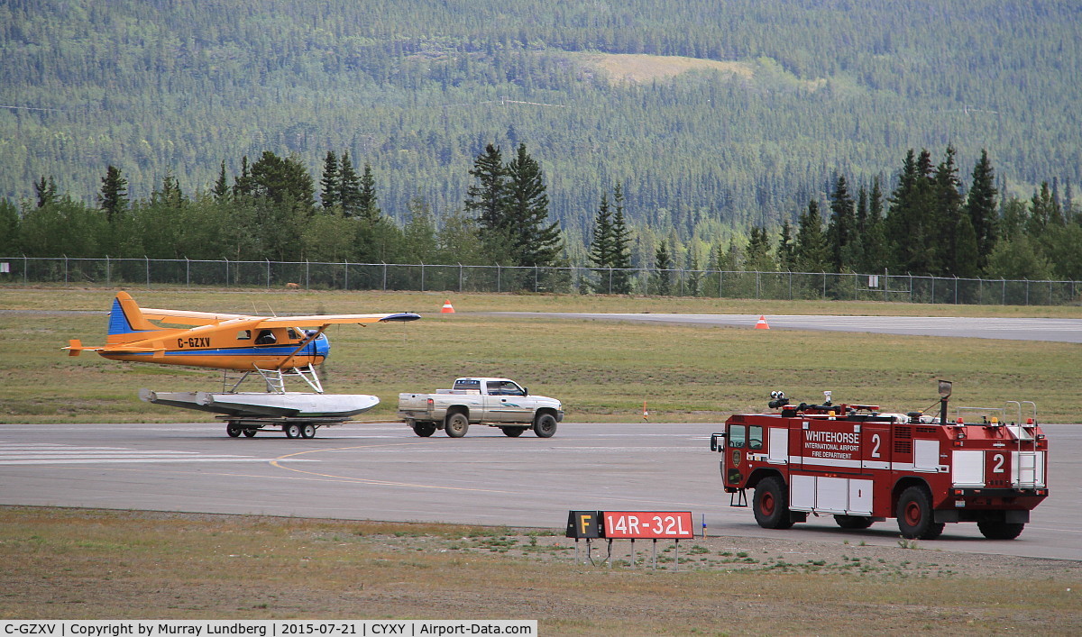 C-GZXV, 1957 De Havilland Canada U-6A Beaver C/N 1079, On floats, being launched from a trailer on a paved runway at Whitehorse, Yukon.