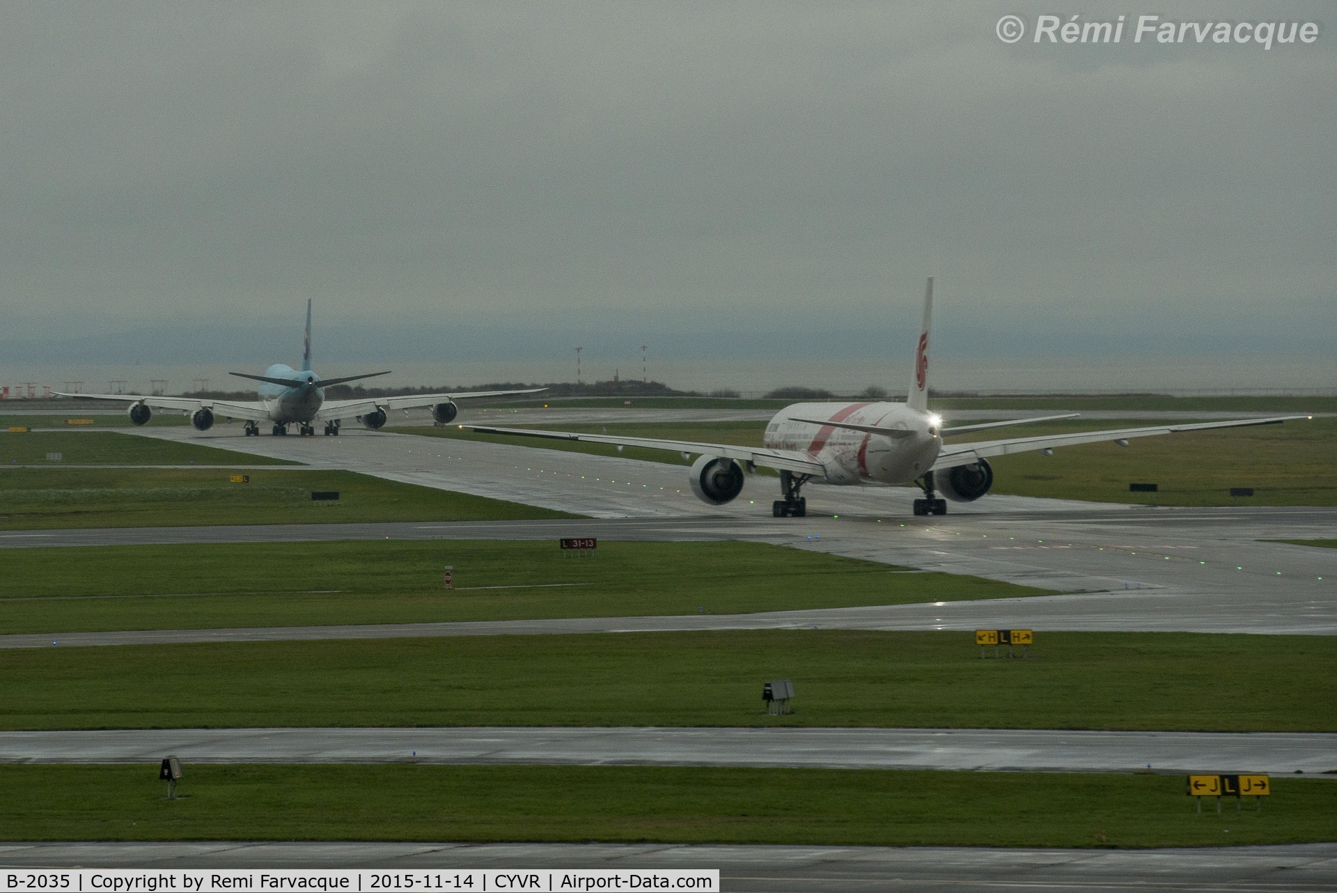 B-2035, 2012 Boeing 777-39L/ER C/N 38674, In foreground, taxiing to departure runway.