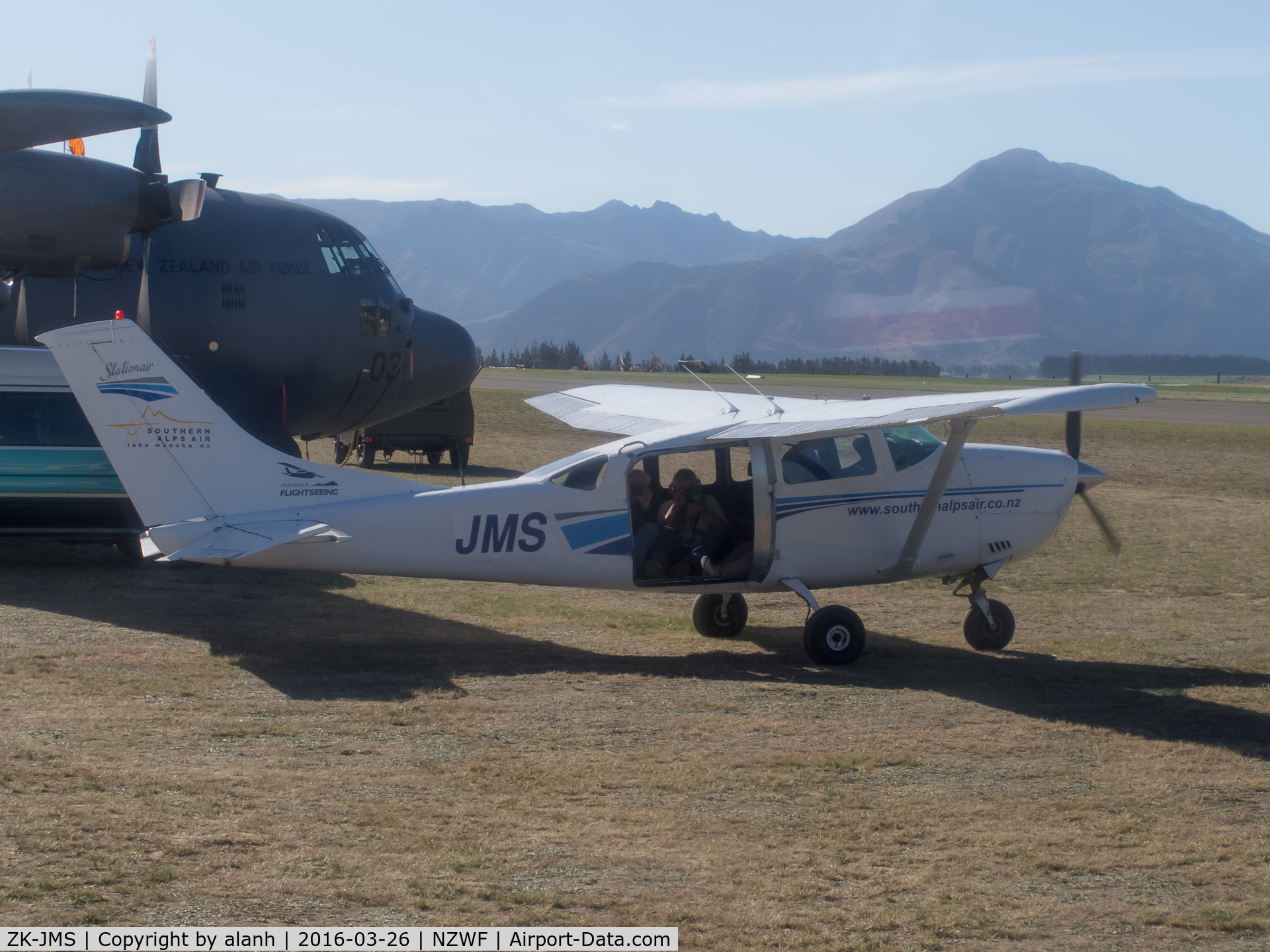 ZK-JMS, Cessna U206F Stationair C/N U20601838, Taken from Catalina ZK-PBY at Wanaka, after the Saturday airshow. There are 3 photographers in the back of JMS for an air to air shoot with the Catalina.