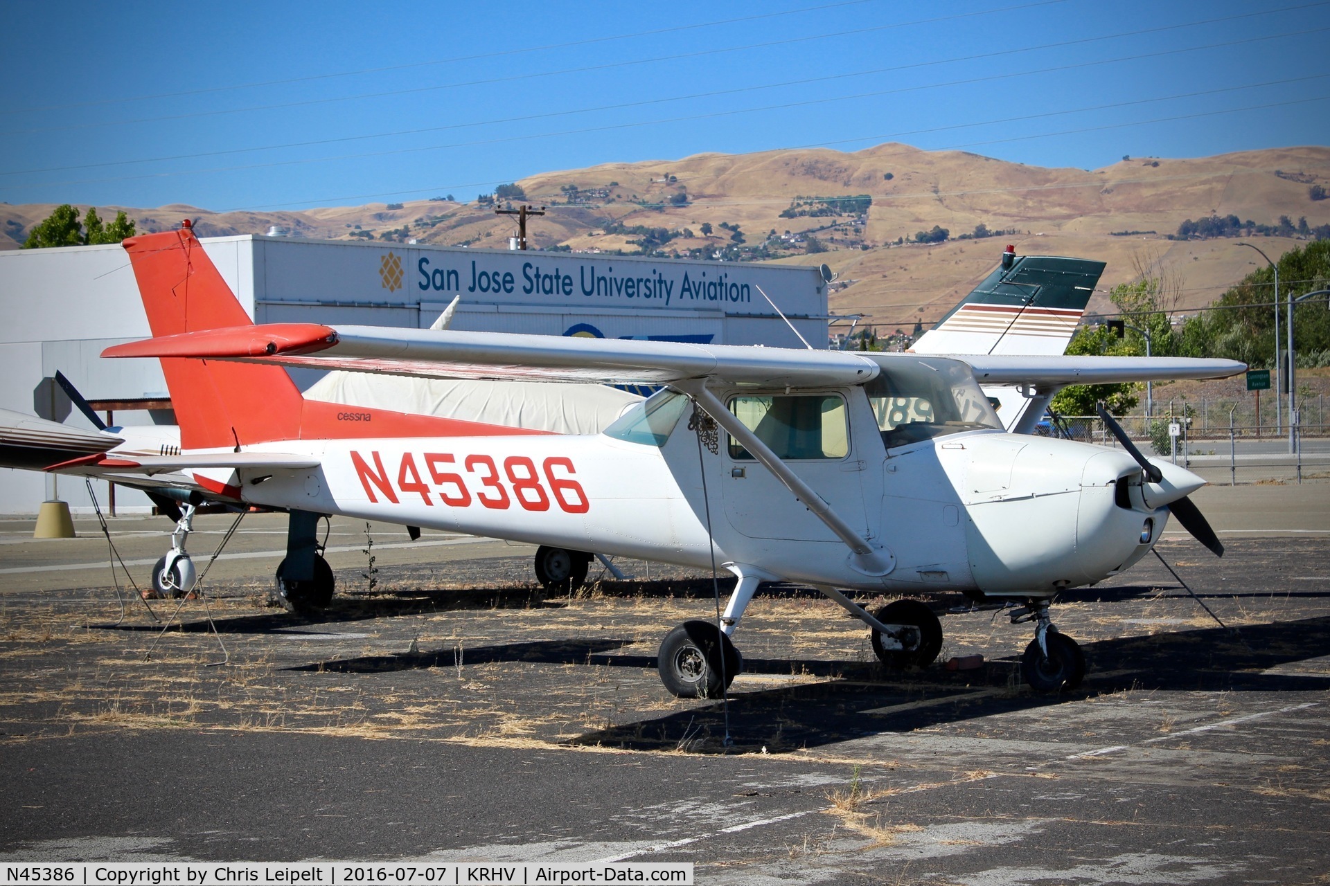 N45386, 1975 Cessna 150M C/N 15076895, SJSU (San Jose, CA) 1975 Cessna 150M parked with their hangar in the background at Reid Hillview Airport, San Jose, CA.