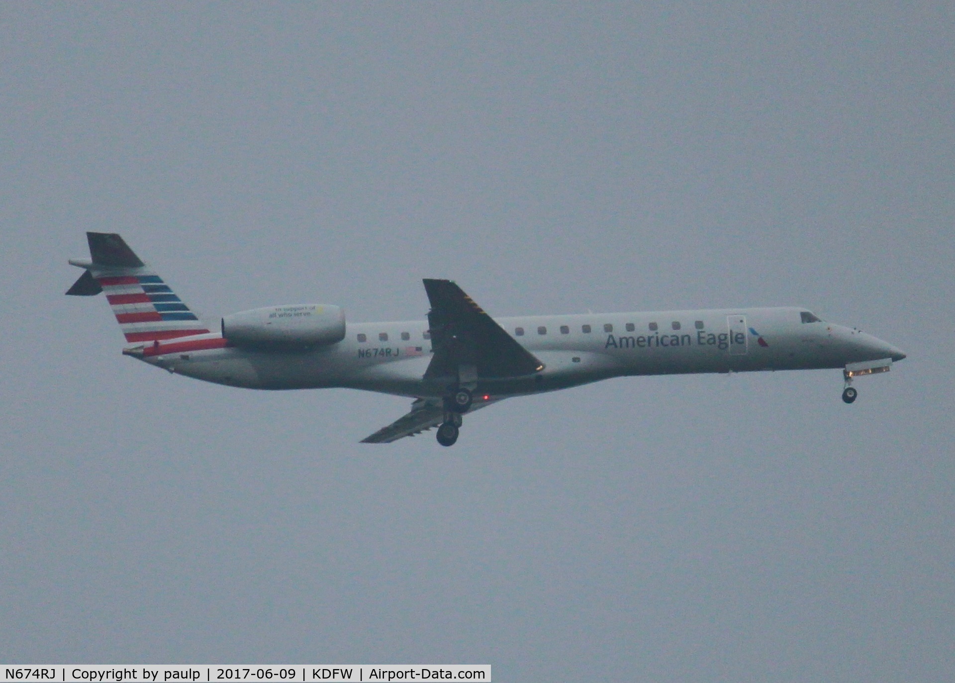N674RJ, 2004 Embraer ERJ-145LR (EMB-145LR) C/N 14500801, At DFW. After a 45 minute hold because of severe storms, starting to land in heavy rain.