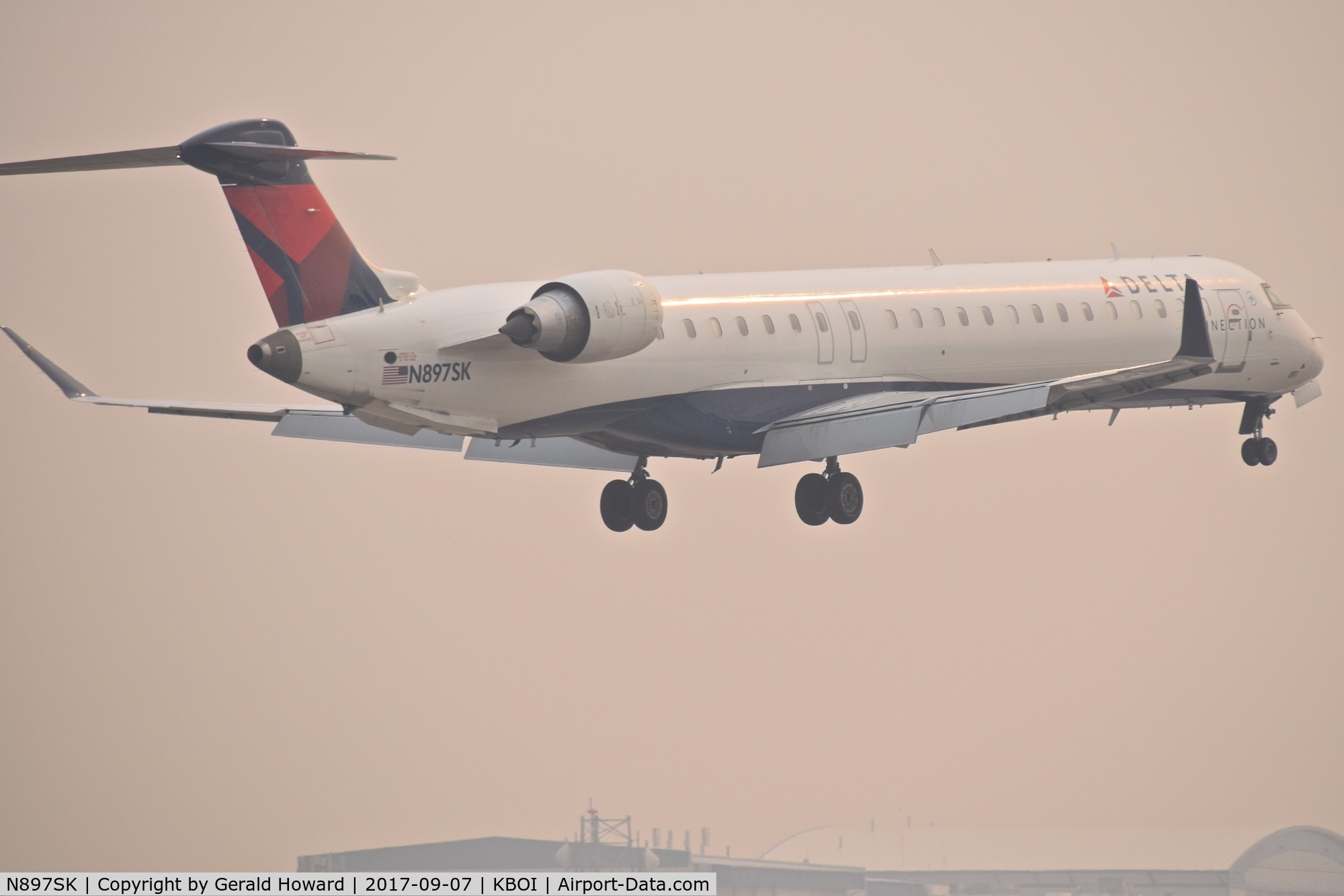 N897SK, 2006 Canadair CRJ-900LR (CL-600-2D24) C/N 15103, IFR landing on RWY 10R.  1 & 3/4 mile smoke.