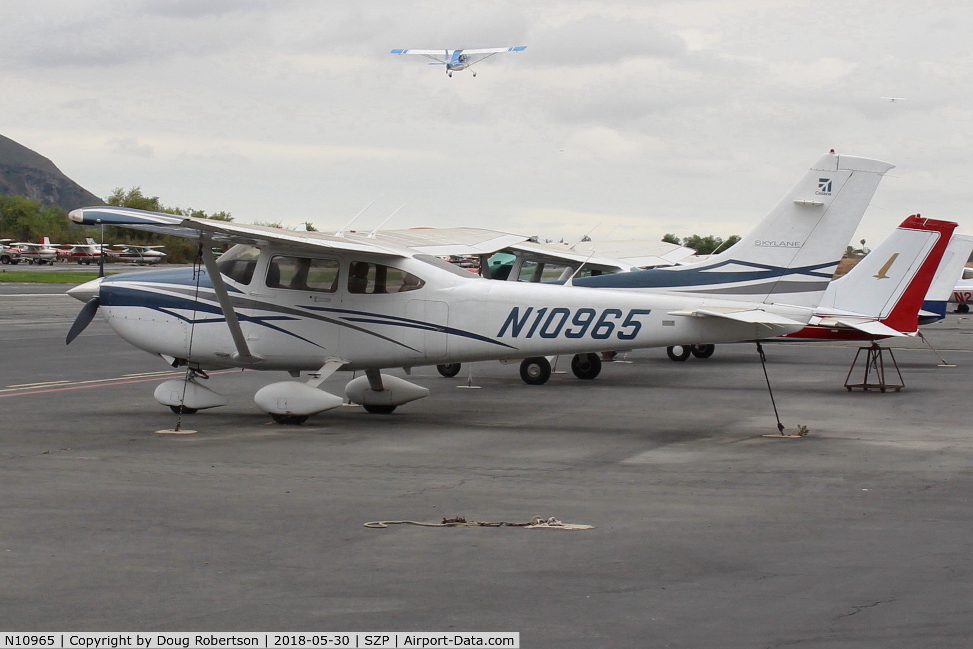 N10965, 2007 Cessna 182T Skylane C/N 18281976, 2007 Cessna 182T SKYLANE, Lycoming IO-540-AB1A5 230 Hp on transient Ramp, with N117CP on takeoff climb Rwy 22