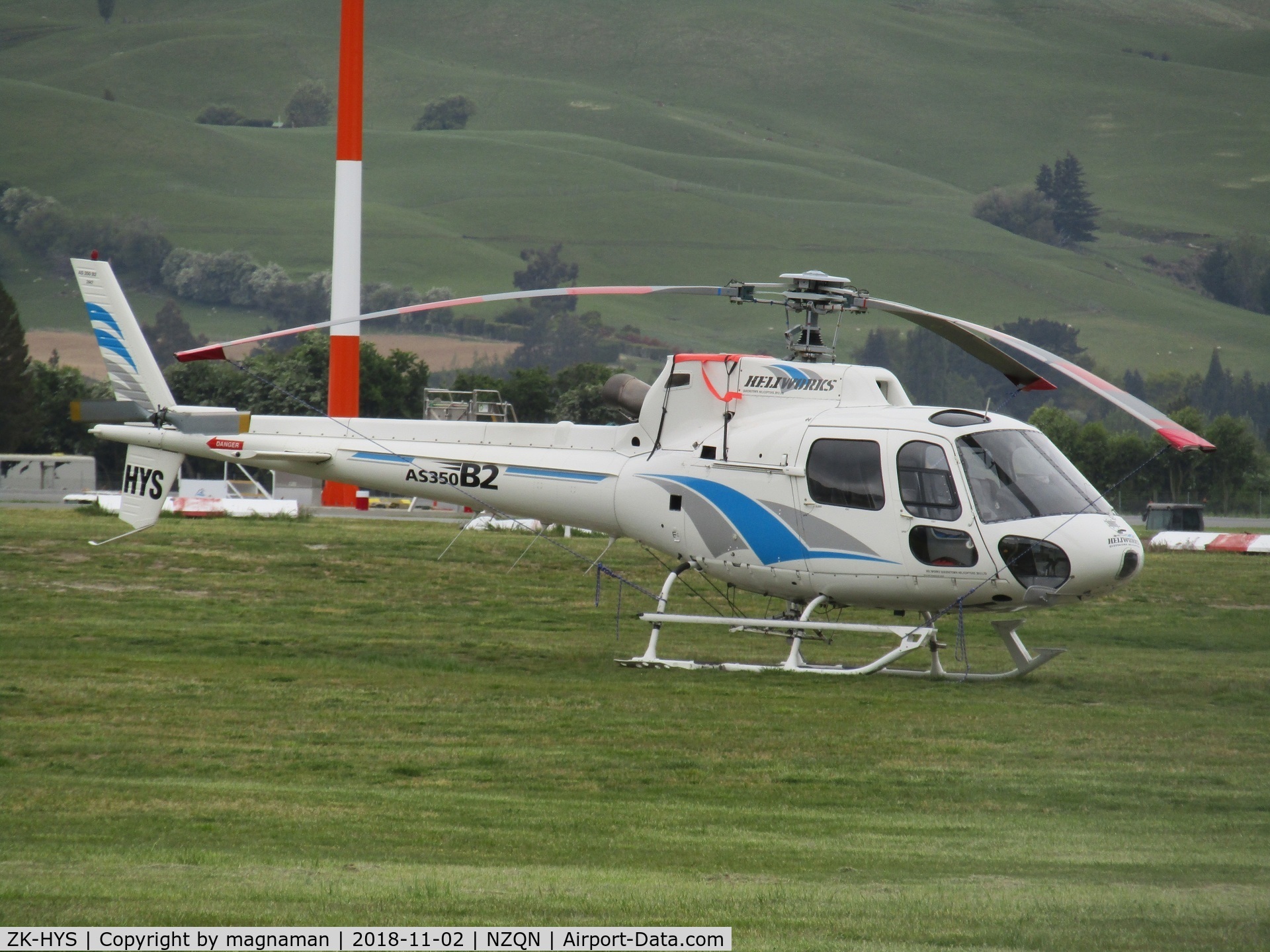 ZK-HYS, Aerospatiale AS-350B-2 Ecureuil C/N 2447, on grass outside hangar at queenstown
