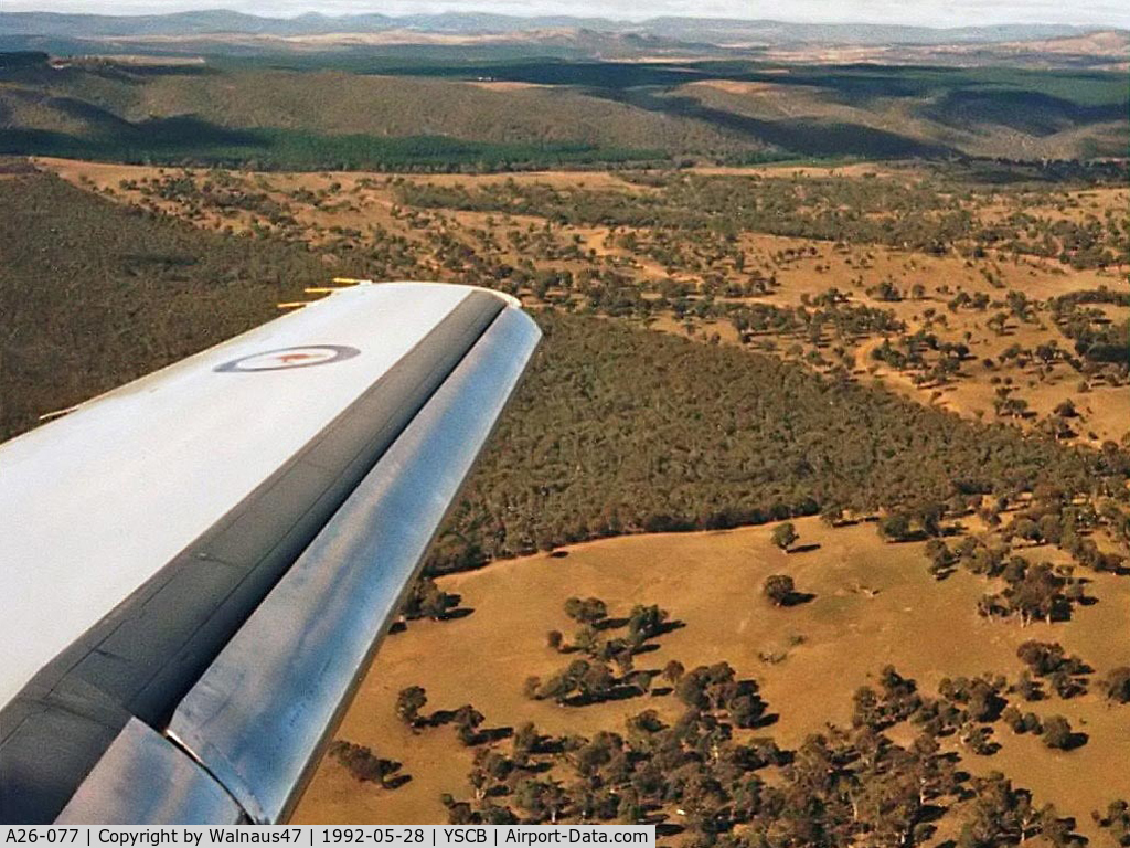 A26-077, 1989 Dassault Falcon 900B C/N 077, Wing View taken from 34 Squadron VIP Falcon 900 A26-077 Cn 77  on approach to Canberra's Rwy 30, at the end of a 0.4 hour flight from Sydney on 28May1992. This photo was taken approaching 34 Squadron's home base - RAAF Base Fairbairn YSCB.