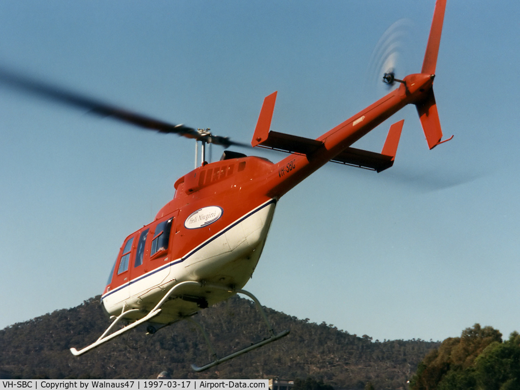 VH-SBC, 1973 Bell 206L-3 LongRanger III LongRanger III C/N 51396, Rear Port side view of Bell 206L-3 LongRanger III VH-SBC Cn 51396 departing towards Lake Burley Griffin Canberra during Canberra Week festivities on 17Mar1997-Canberra Day. Mt Ainslie is at rear. Several Bell JetRangers flew many 5 min joyflights that day