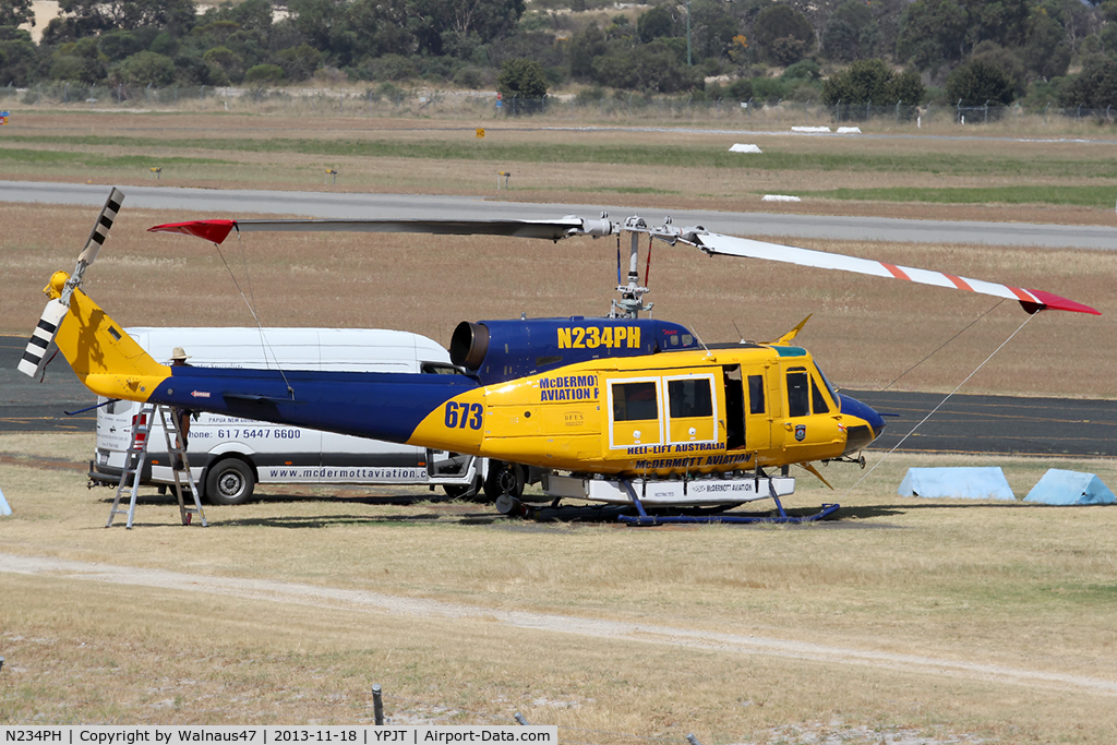 N234PH, 1977 Bell 214B-1 Biglifter C/N 28050, Stbd view of McDermott Aviation Bell 214B-1 Biglifter N234PH Cn 28050 under maintenance at Jandakot Airport YPJT West Australia on 18Nov2013. Equipped with ‘under-cabin’ water tank, with ‘pick-up’ hose, wearing Code Helitack 673.