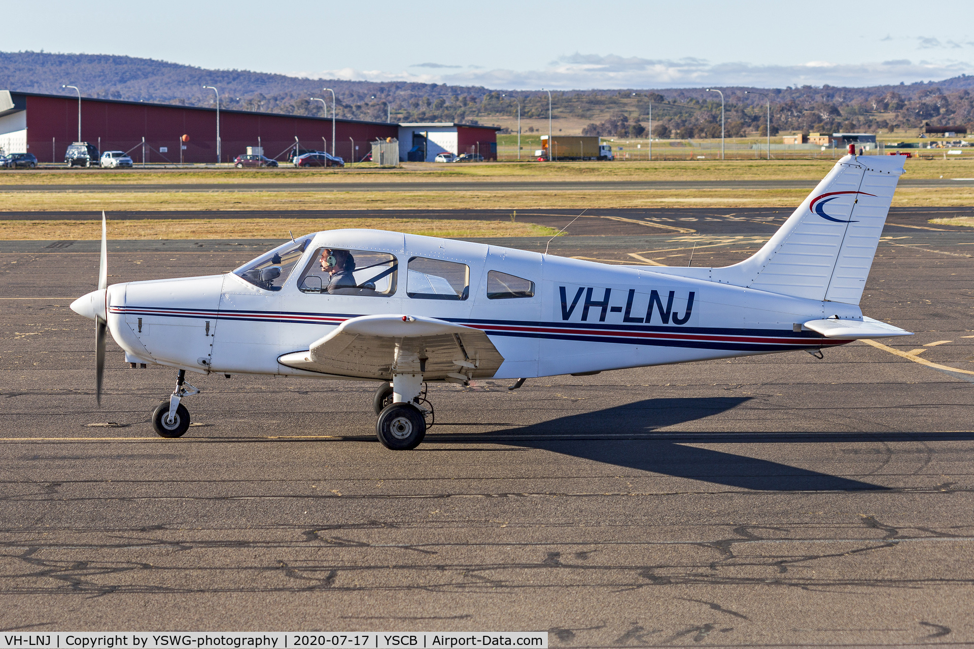 VH-LNJ, 1977 Piper PA-28-151 Cherokee Warrior C/N 28-7715154, Meehan Traders (VH-LNJ) Piper PA-28-151 Cherokee Warrior taxiing at Canberra Airport.