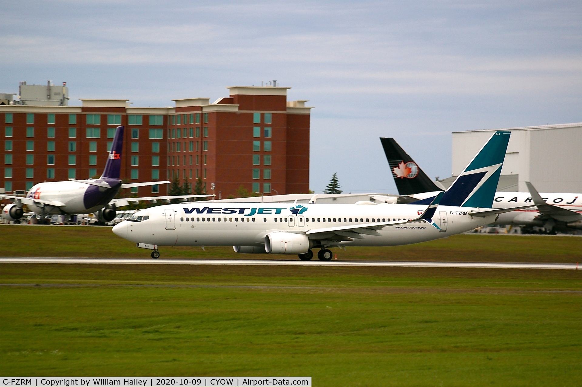 C-FZRM, 2016 Boeing 737-8CT C/N 40840, Westjet 737-8CT departing CYOW runway 25 with a Fedex A300 and Cargojet 767 in the background