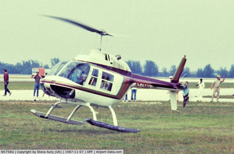 N5758G, Bell 206B C/N 3141, I was on holiday in Florida from the UK and visited the Miami Air Show at Opa-Locka Airport on Saturday 7th November 1987. N5758G is pictured making one of many short pleasure flights throughout the day.