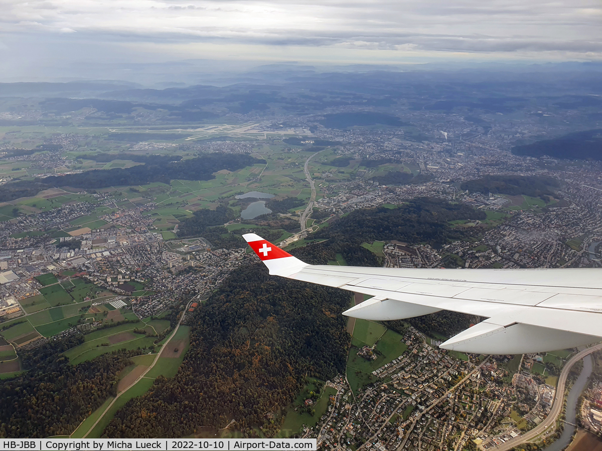 HB-JBB, 2016 Bombardier CSeries CS100 (BD-500-1A10) C/N 50011, Climbing out of Zurich, with a view back to the airport (ZRH-ARN)