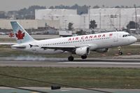 C-FTJP @ LAX - Air Canada C-FTJP touching down with the right main gear on RWY 7R. - by Dean Heald