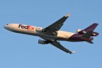 N584FE @ LAX - FedEx N584FE (MD-11F) departing LAX RWY 25L on an early morning in November. - by Dean Heald