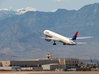 N187DN @ KLAS - Delta Airlines against the background of the Spring Mountains and Mt. Charleston - by SkyNevada - Brad Campbell