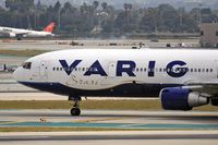 PP-VTJ @ LAX - Close-up of Varig PP-VTJ (FLT VRG8836) on taxiway Tango, about to cross RWY 25R after arrival on RWY 25L from Guarulhos Int'l (SBGR)-Sao Paulo, Brazil. In the background, Northwest Airlines (FLT NWA627) is arriving on RWY 24R from McCarran Int'l (KLAS).
