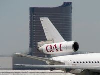 N720AX @ KLAS - Omni Air International /  Mcdonnell-douglas DC-10-30 / The Wynn Hotel & Casino in background with DC10 taxi to RWY 25R - by Brad Campbell