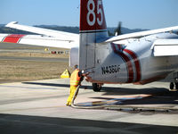N438DF @ STS - Ground crewman hooks up retardent hose to CDF S-2T Tanker #85 at Sonoma County Airport, CA air attack base - by Steve Nation