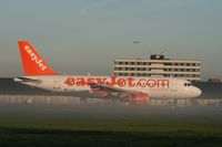 G-EZIS @ AMS - Easyjet A319 in early morning ground mist - by Mark Giddens