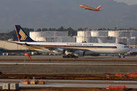 9V-SGB @ LAX - Singapore Airlines 9V-SGB taxiing to the Tom Bradley International Terminal  after arrival on the north complex. Southwest FLT 2658 climbing out from RWY 24L enroute to Nashville can be seen in the background. - by Dean Heald