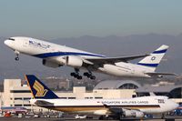 4X-ECB @ LAX - EL AL Israel Airlines 4X-ECB (FLT ELY6) climbing out from RWY 25R enroute to Tel Aviv.  Singapore Airlines Cargo 9V-SFL is taxiing to the cargo terminal after arrival on the north complex. - by Dean Heald