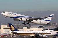 4X-ECB @ LAX - EL AL Israel Airlines 4X-ECB (FLT ELY6) climbing out from RWY 25R enroute to Tel Aviv.  Singapore Airlines Cargo 9V-SFL is taxiing to the cargo terminal after arrival on the north complex.
