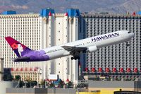 N593HA @ LAS - Hawaiian Airlines N593HA (FLT HAL7) climbing out from RWY 01R, in front of the Excalibur Hotel & Casino, enroute to Honolulu Int'l (PHNL).