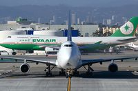 9V-SFN @ LAX - Singapore Airlines Cargo 9V-SFN (FLT SQC7986) crossing RWY 25L on taxiway ST enroute to the cargo terminal after arrival on the north complex from Ted Stevens Anchorage Int'l (PANC). EVA Air B-16411 in the background is being towed to the remote terminal.