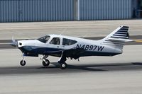N4897W @ SMO - Michael Reznick's 1977 Rockwell Commander 114 landing on RWY 21. - by Dean Heald