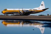 C-GHZI @ CYQF - Air Spray Lockheed Electra - reflection - by Yakfreak - VAP