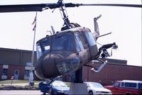 66-15185 @ ALO - UH-1M mounted on a post at the Army National Guard armory