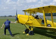 G-AOBH @ EGNW - The traditional way of starting an aircraft is demonstrated with this Tiger Moth. A hardly seen procedure nowadays. - by Joop de Groot