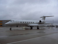 N102BG @ GKY - ON the ramp at Arlington Municipal...in the cold rain - by Zane Adams