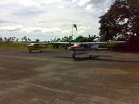6Y-JTC @ MKNG - Picture of Tara Courier Services Ltd aircraft - # 6Y-JTC (Yellow Cessna on the left) Taken at Negril Aerodrome Jamaica - by Michael James