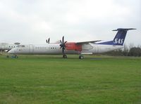 LN-RDQ @ EGTE - DHC-8-400 in the storage area at Exeter - by Simon Palmer