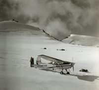 N9716B - unloads people and supplies in the upper cirque of McCall Glacier, with the IGY camp in the background - by Austin Post
